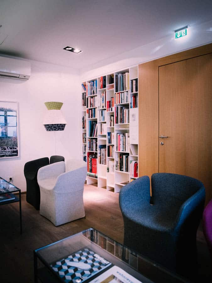 Cozy reading corner Cozy room with modern armchairs and a well-stocked bookshelf
